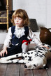 Serious pretty little boy in medieval costume sits